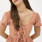FRONT BOW DETAIL PUFF SLEEVE PEPLUM TOP